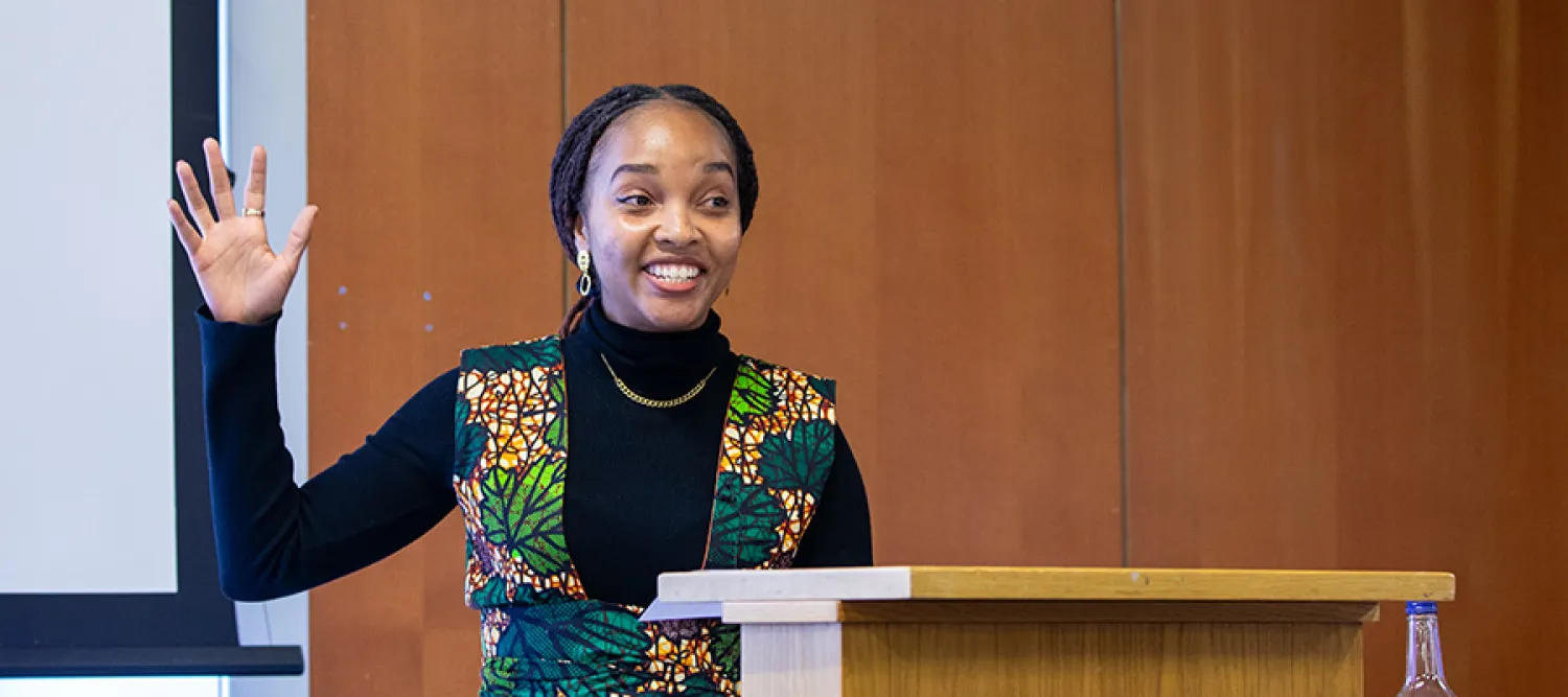Young women with her hand raised giving a presentation