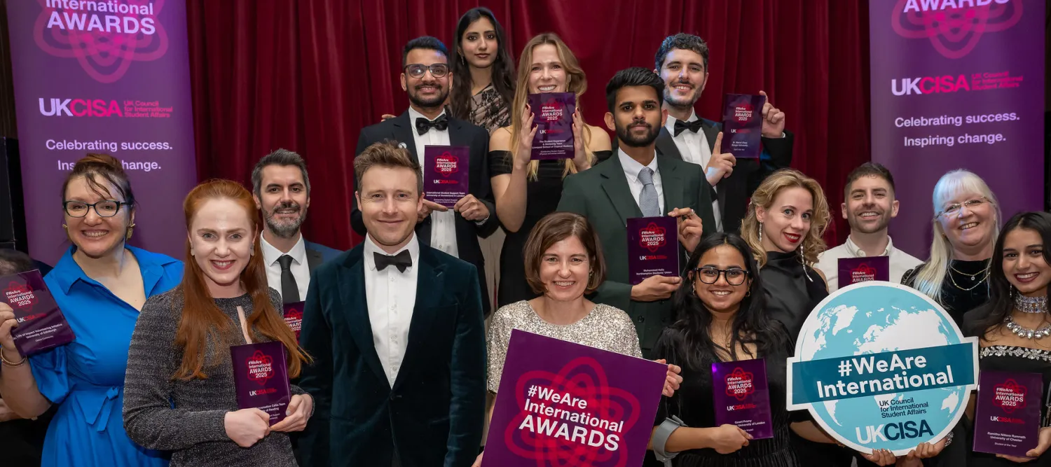 A group of people holding awards and smiling.
