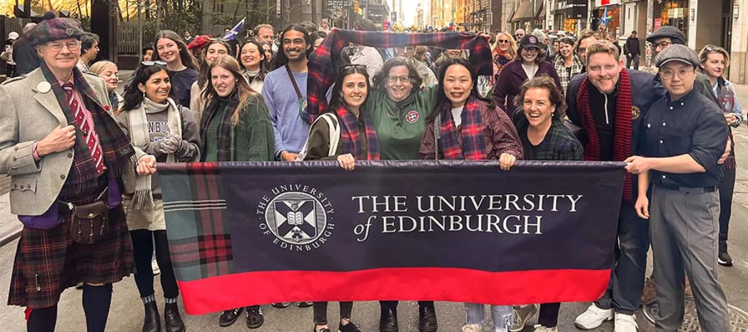A group of people holding a University of Edinburgh sign and wearing tartan at the 2026 Tartan Day parade in New York City.