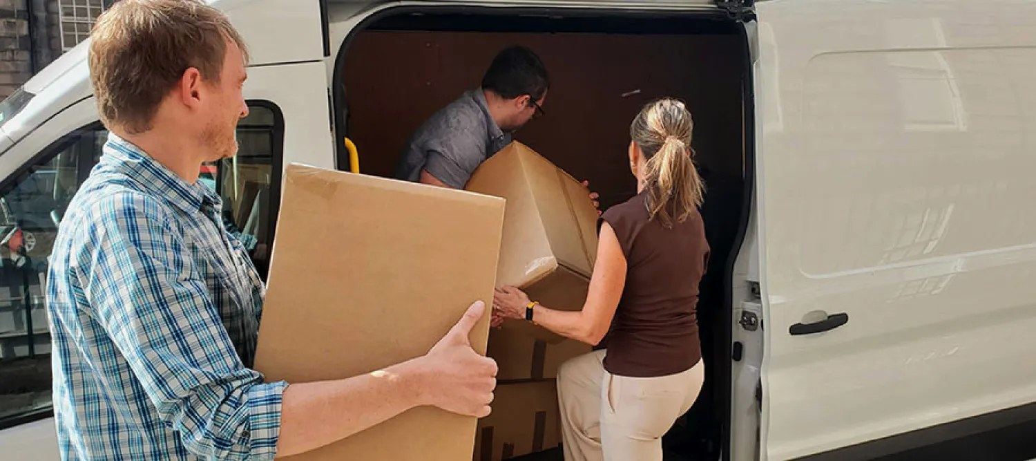 Staff loading boxes into a white van
