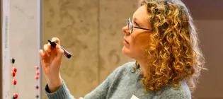 A women writing on a whiteboard
