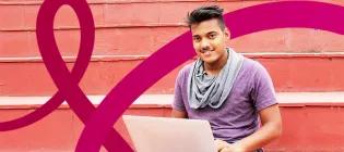 Male scholar working on laptop with EBB branding in the background