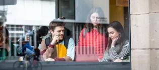 Three students looking at a computer.