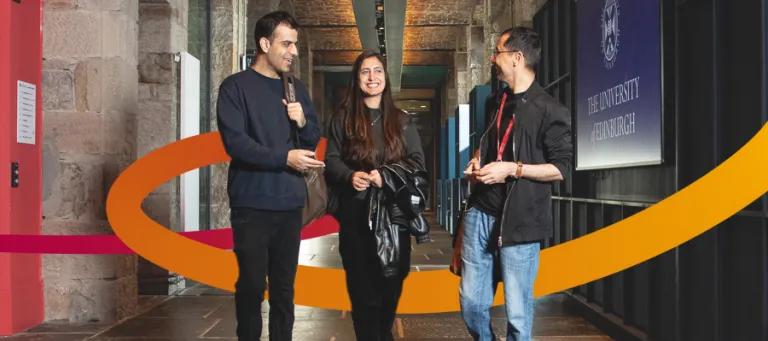 Three students walking down a hallway speaking, with an orange swoosh behind them.