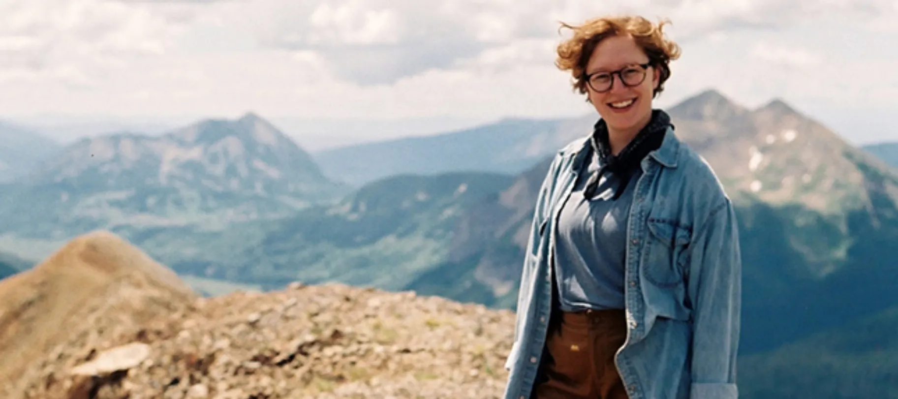 woman smiling in front of hills