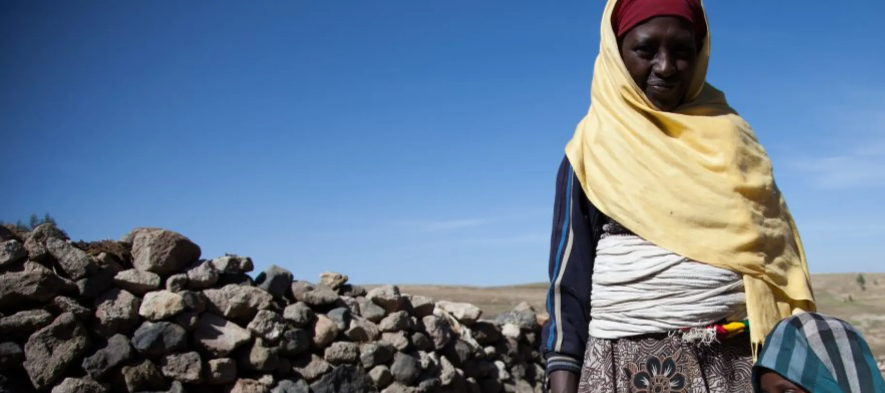 Farmer, daughter and newborn lamb in Ethiopia.