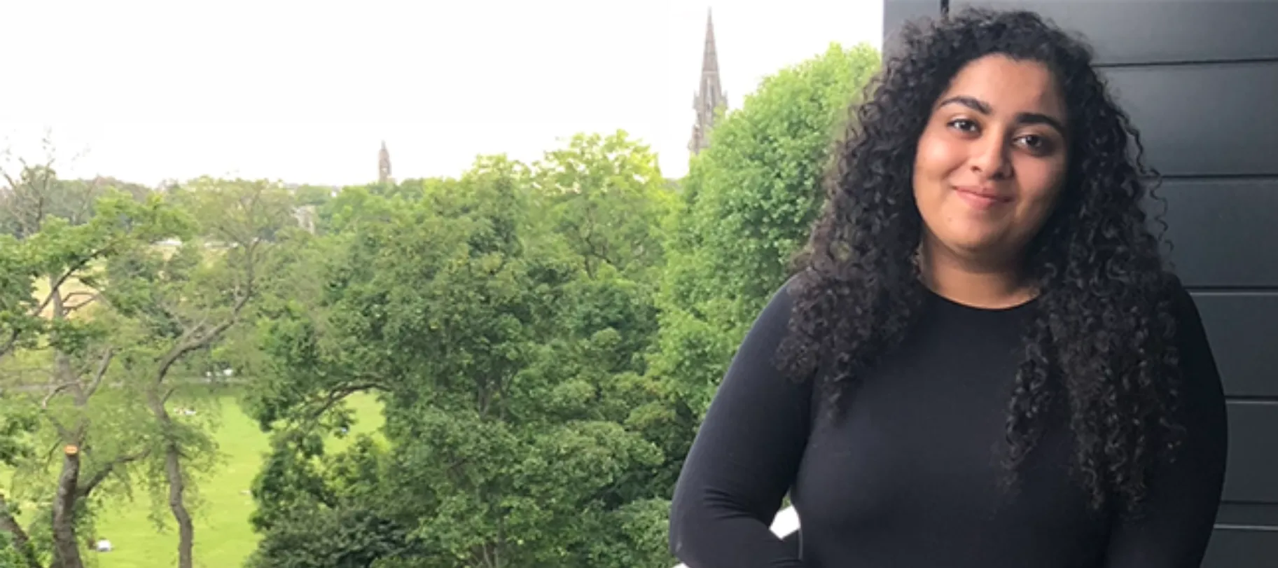 woman smiling above trees