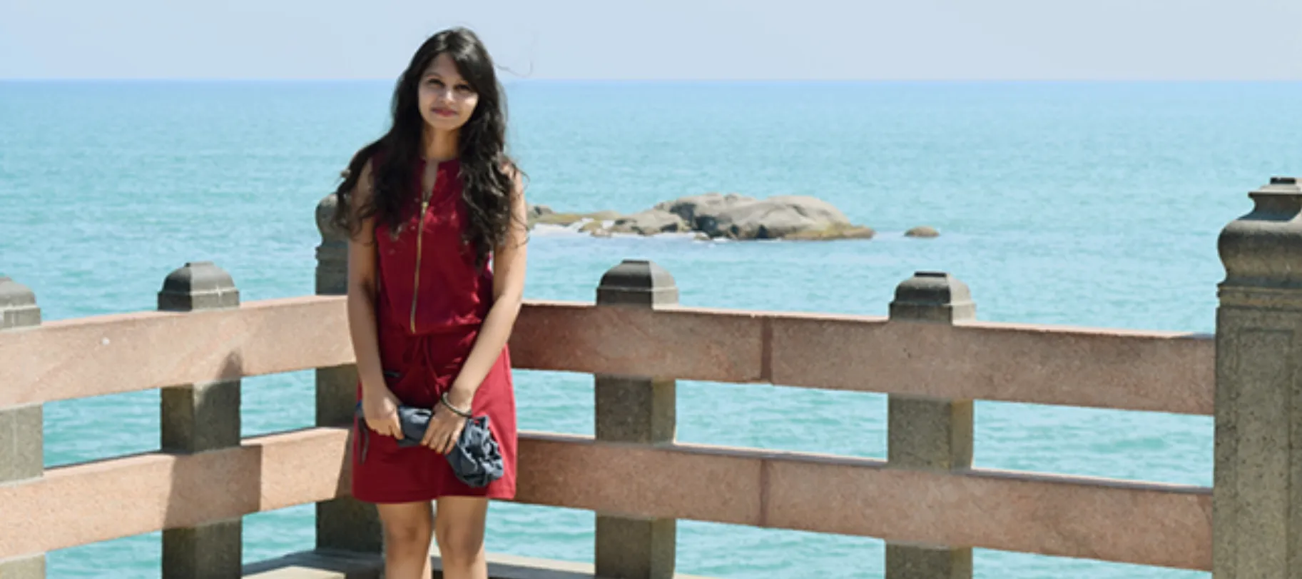 woman smiling in front of the sea
