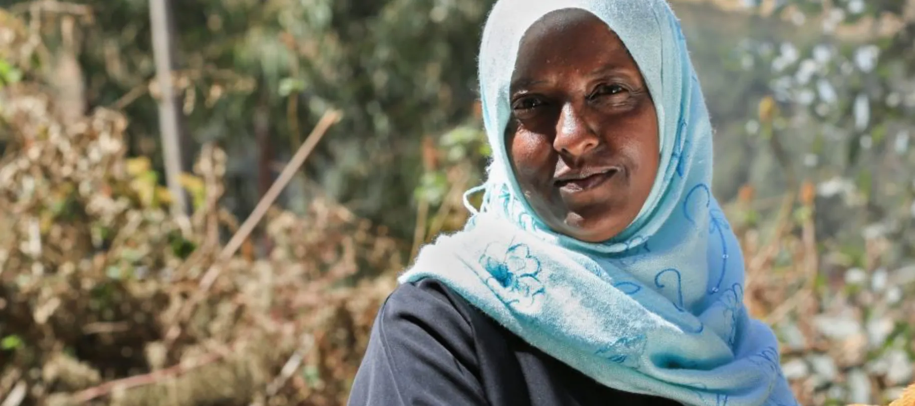 Woman farmer with her chicken in Ethiopia