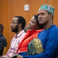 Audience members listening