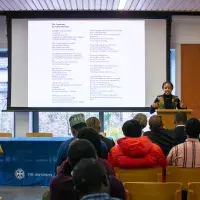 A person presenting in front of a room 