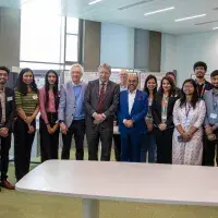 Professor Sir Peter Mathieson with GBU students and staff at their poster presentation