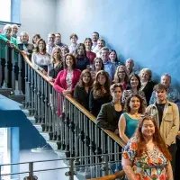 A large group of students and staff posing for a photo on the stairwell of the Edinburgh Futures Institute.