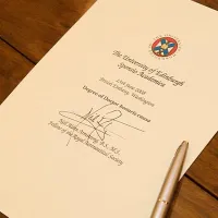 A piece of paper on a table, with text demonstrating that it's a University of Edinburgh honorary degree for Neil Armstrong..