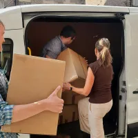 Staff loading boxes into a white van