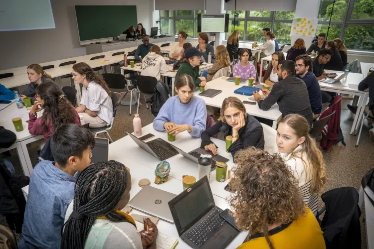 Summer school students working in groups at desks