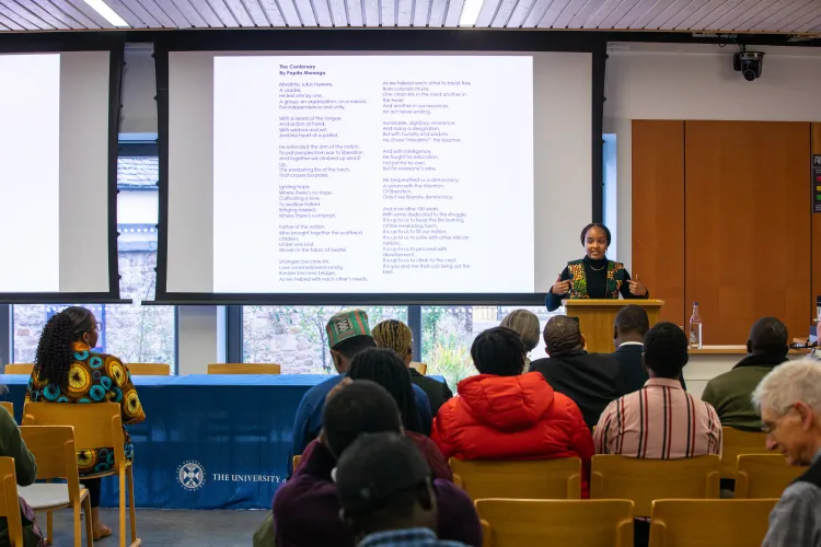 A person presenting in front of a room 