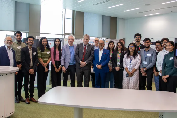 Professor Sir Peter Mathieson with GBU students and staff at their poster presentation