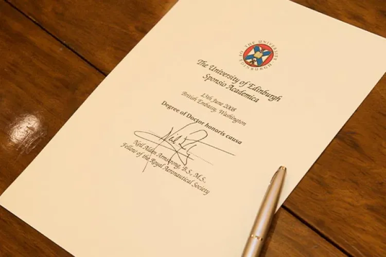 A piece of paper on a table, with text demonstrating that it's a University of Edinburgh honorary degree for Neil Armstrong..