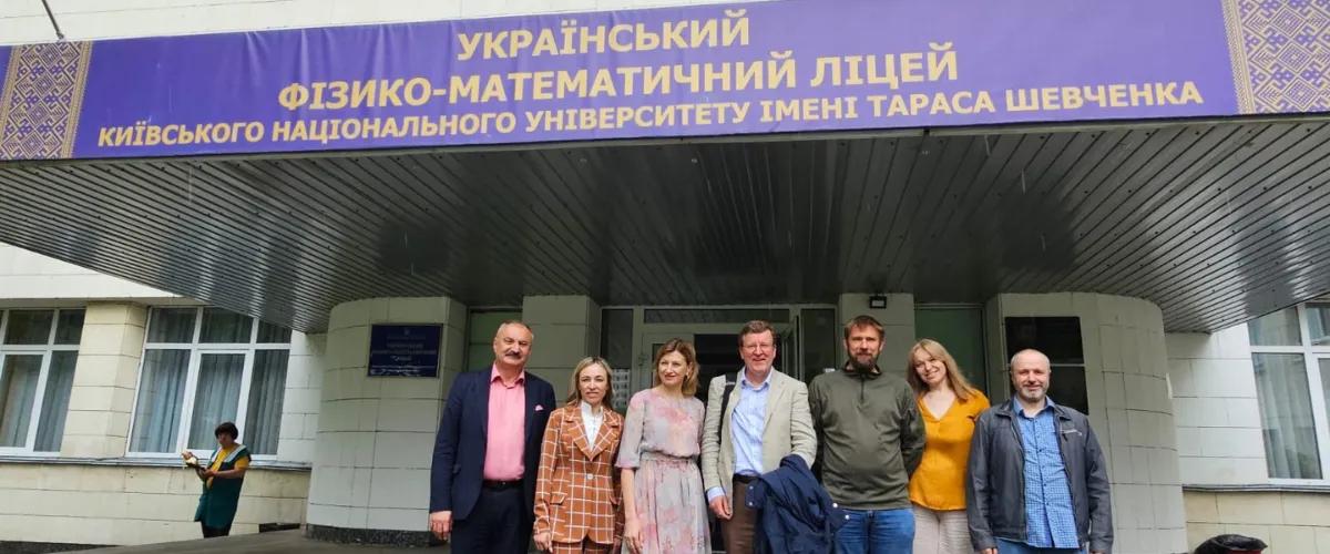 Professor Charles Cockell with 6 KNU colleagues standing outside the Lyceum of Physics and Mathematics