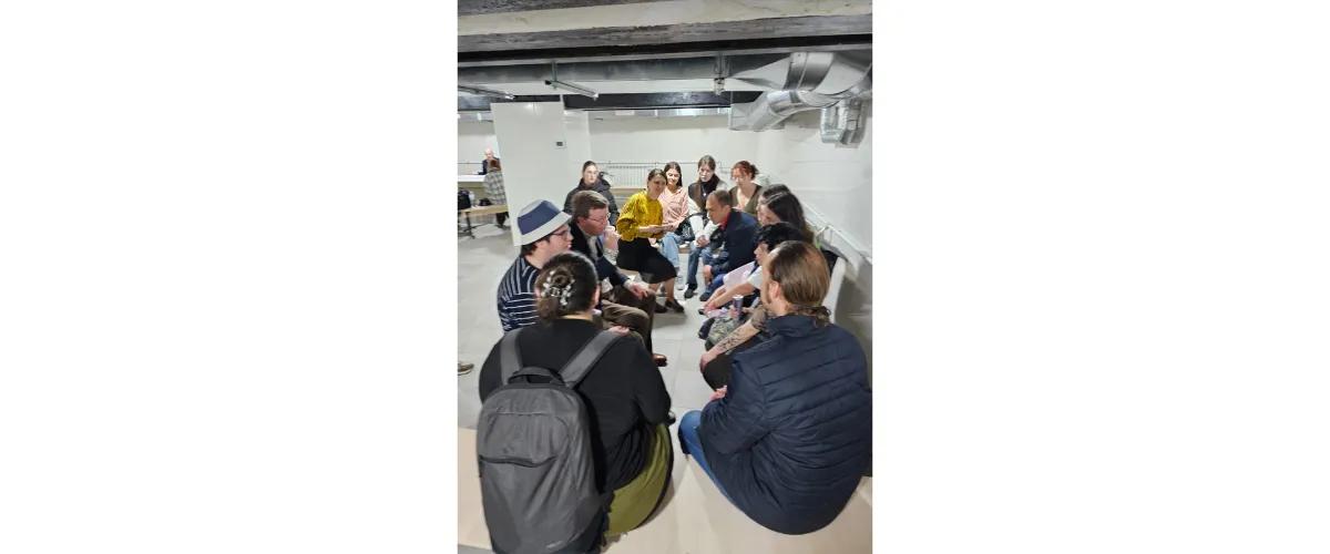 Professor Charles Cockell surrounded by his students, continuing a lecture in a bomb shelter