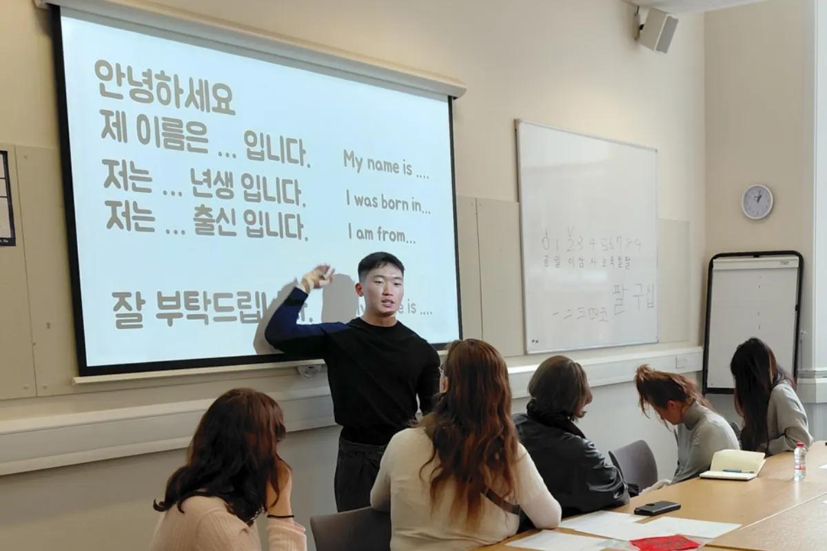 A man teaching Korean to a class