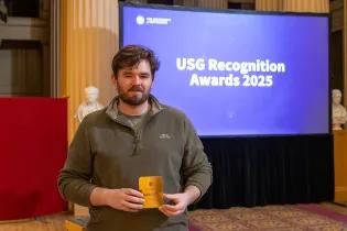 Michael MacLennan collects the Changemakers USG Award at Playfair Library