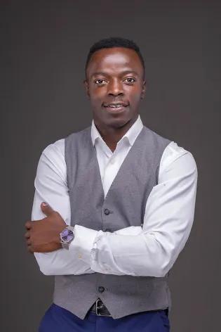 Headshot of Edgar Onyango in a suit, smiling at the camera.