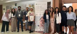 10 students smiling and standing around a banner that reads "Una Europa Summer School: Innovative Methods in Future Materials".